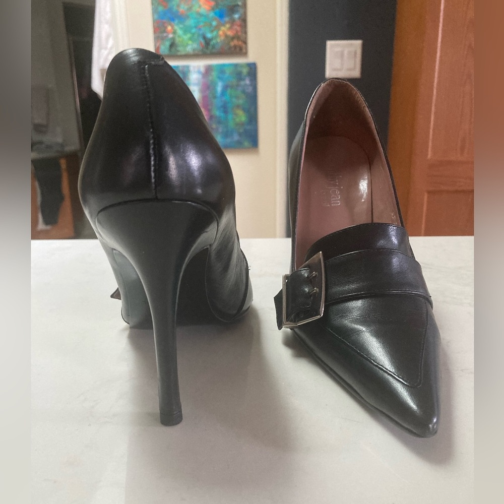 Black leather stilettos. Pointed toe with strap and large buckle Size 8. 4” heel